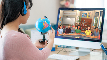 Student looking at computer screen that shows illustration of a simulated classroom